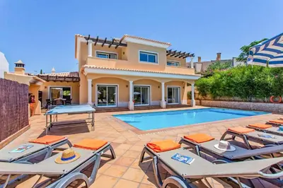 a villa with a swimming pool in front of a house at Villa Helene Norvilla in Galé