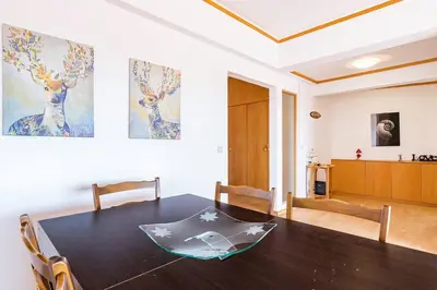 a dining room with a table and a living room at TAC - Sunrise Montechoro Albufeira in Albufeira