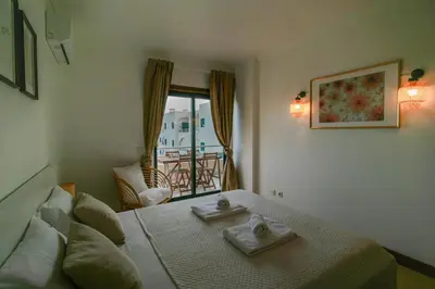 a bedroom with a bed with two towels on it at FLH Salgados Balcony Flat in Albufeira