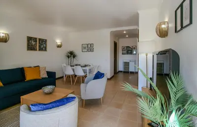 a living room with a couch and a table at FLH Salgados Balcony Flat in Albufeira