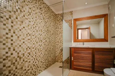 a bathroom with a shower with a mirror and a sink at FLH Salgados Balcony Flat in Albufeira
