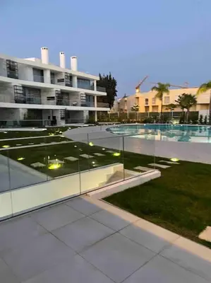 a view of a building with a lawn and a courtyard at Lakes 24 - Av Praia da Falésia in Quarteira