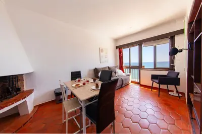 a living room with a table and a couch at Seacliff Albufeira in Albufeira