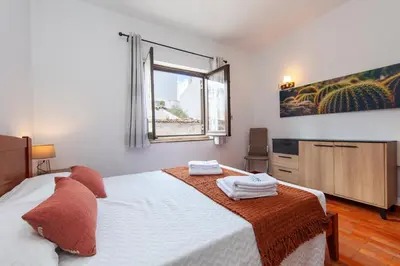 a bedroom with a bed with towels on it at Seacliff Albufeira in Albufeira