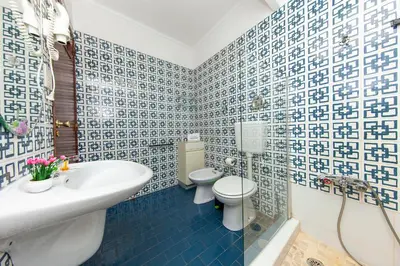 a bathroom with a toilet and a sink at Seacliff Albufeira in Albufeira