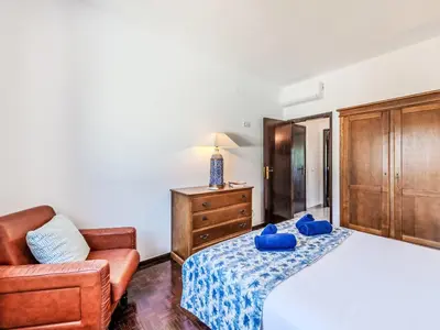 a bedroom with a bed and a couch and a chair at Holiday Home Antonica by Interhome in Patroves