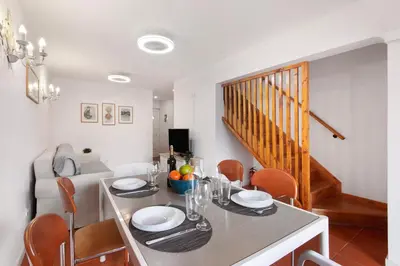 a dining room with a white table and chairs at Cool Motion 2149 in Albufeira