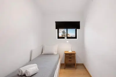 a small bedroom with a bed and a window at Cool Motion 2149 in Albufeira