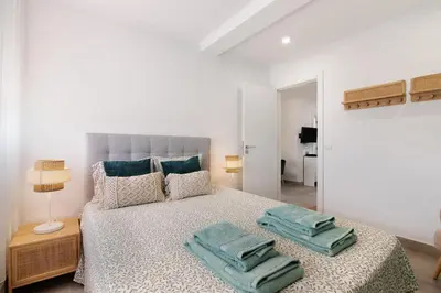 a bedroom with a bed with green pillows on it at Stunning Modern Apartment In Oura in Albufeira