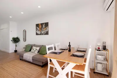 a kitchen and dining room with a table and chairs at Lovely And New Apartment In Oura in Albufeira