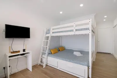 a living room with a couch and a mirror at Lovely And New Apartment In Oura in Albufeira
