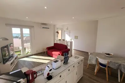 a living room with a red couch and a table at Sea View Apartment Faro in Faro