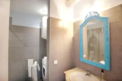 a bathroom with a blue mirror and a sink at Marimar Sea View Apartment Faro in Faro