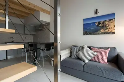 a living room and kitchen with a couch and a sink at Faro Ria Formosa Twin at city center in Faro