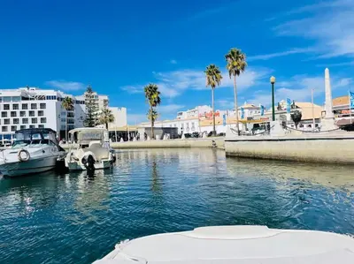 two boats are docked in a body of water at Faro Ria Formosa Twin at city center in Faro