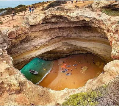 a group of people on a beach in a cave at Faro Ria Formosa Twin at city center in Faro