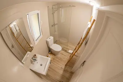 a white bathroom with a toilet and a shower at Vilamoura Beach Villa with Private Pool in Quarteira