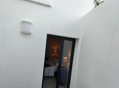a white building with a door leading to a bedroom at Typical house Faro downtown private entrance in Faro