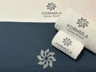two towels sitting on top of a bed at Carteia Mar by FHR frente Mar & piscina in Quarteira