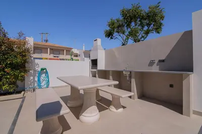a picnic table and benches on a patio at Sirius House in Guia