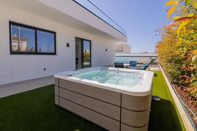 a hot tub in the backyard of a house at Sirius House in Guia