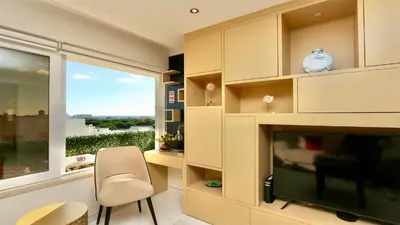 a living room with a fireplace and a window at MouraSuites CD 601 - Cleverdetails in Vilamoura