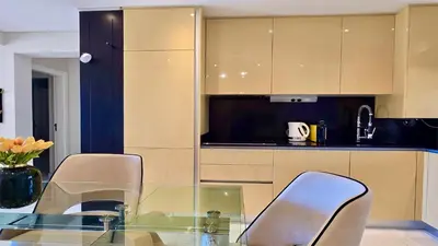 a kitchen with a glass table and two chairs at MouraSuites CD 601 - Cleverdetails in Vilamoura