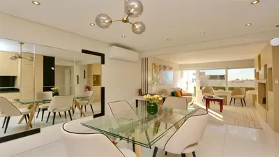 a dining room and living room with a glass table and chairs at MouraSuites CD 601 - Cleverdetails in Vilamoura