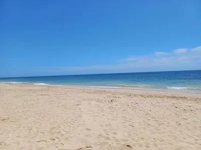 a sandy beach with the ocean in the background at Balaia Praia in Albufeira