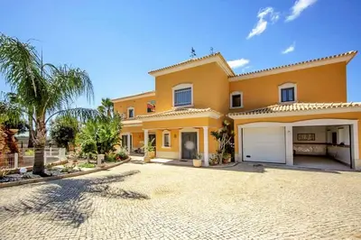 a large yellow house with a large driveway at Quinta do Sol in Guia