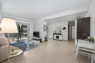 a living room with a couch and a table at Areias Branca in Quarteira