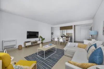 a living room with a couch and a table at Sol e Mar in Quarteira