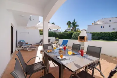 a dining table and chairs on a patio at Apartment Zeza in Albufeira