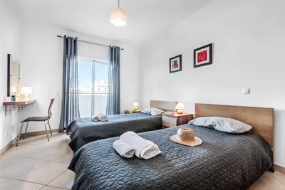 a bedroom with two beds with towels on them at Villa Felizalgarve in Albufeira