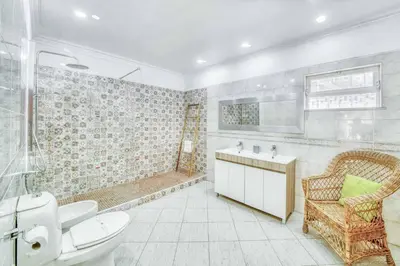 a bathroom with a toilet sink and a shower at Villa Garbino in Albufeira