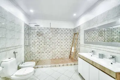 a bathroom with a toilet and a sink and a shower at Villa Garbino in Albufeira