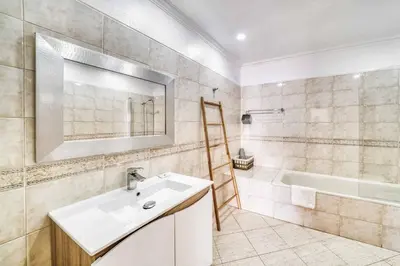 a bathroom with a sink and a bath tub at Villa Garbino in Albufeira