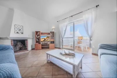 a living room with a couch and a coffee table at Villa Alecrim in Albufeira