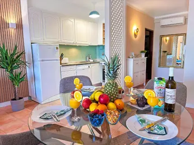 a glass table with fruit on it in a kitchen at OceanView Apartment by BeCherish in Albufeira