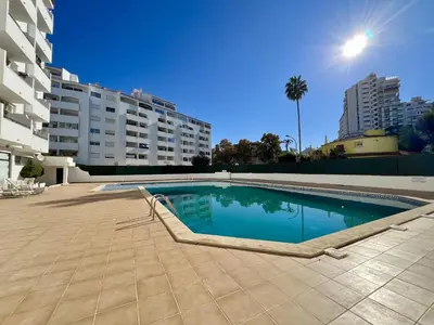 a swimming pool in the middle of a building at Albufeira Town Apartment With Pool by Homing in Albufeira