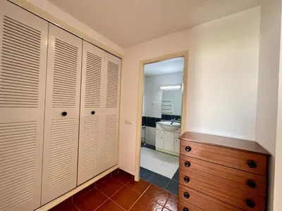 a bedroom with a dresser and a mirror at Albufeira Central 9 by Homing in Albufeira