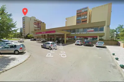 a parking lot with cars parked in front of a building at BLUE - Vilamoura in Vilamoura