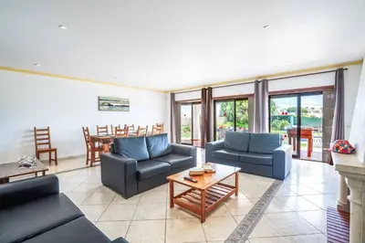 a living room with two couches and a table at Villa Palawan in Galé