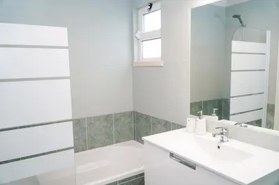 a white bathroom with a sink and a mirror at Apartment Berardo - Perfect for families in Albufeira