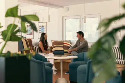 a man and woman sitting in a living room at Outsite Vilamoura in Quarteira