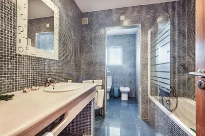 a bathroom with a sink and a tub and a toilet at Villa Casa Sol in Albufeira