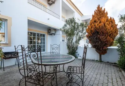a patio with a table and chairs in front of a building at Apartment Nidio - Great Location in Albufeira