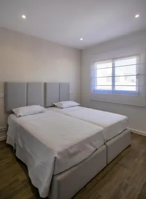 a large white bed in a bedroom with a window at Crystal bay in Albufeira
