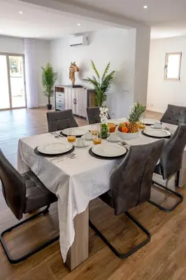 a dining room table with a white table cloth on it at Crystal bay in Albufeira