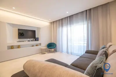 a kitchen with a white counter and a clock on the wall at Vale Mangude B by MTPhomes in Albufeira